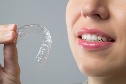 Smiling Woman with silicone trainer. Invisible braces , how does invisalign work